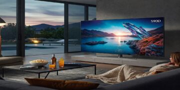 Samsung S90D OLED TV displayed in a modern living room setting showing vibrant picture quality.